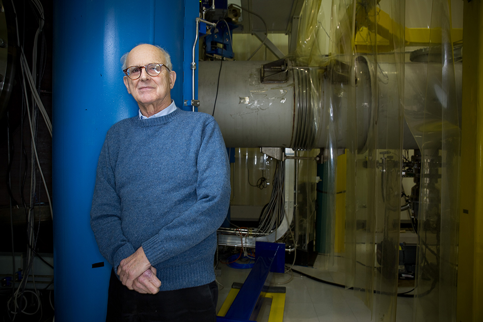 Rainer Weiss leaning up against blue pipe