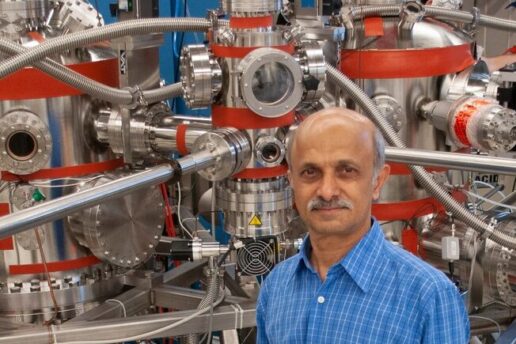 Senior Research Scientist Jagadeesh Moodera poses in front of a molecular beam epitaxy system