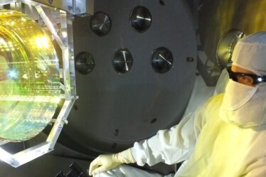 LIGO optics technician inspects one of LIGO’s mirrors