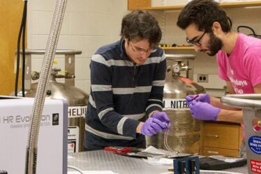 Riccardo Comin (left), an assistant professor of physics, and physics graduate student Abraham Levitan in lab.