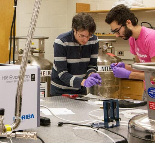 Riccardo Comin (left), an assistant professor of physics, and physics graduate student Abraham Levitan in lab.