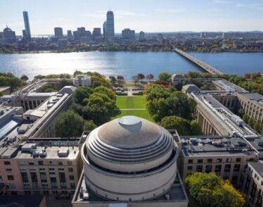 Aerial photo of the MIT dome and Killian Court facing the Charles River and Boston.
