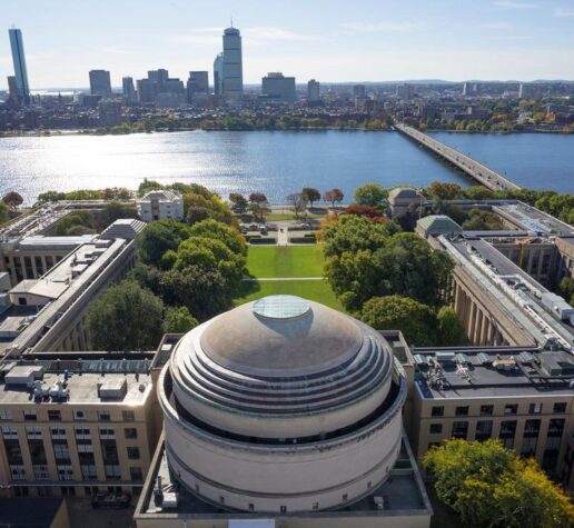 Aerial photo of the MIT dome and Killian Court facing the Charles River and Boston.