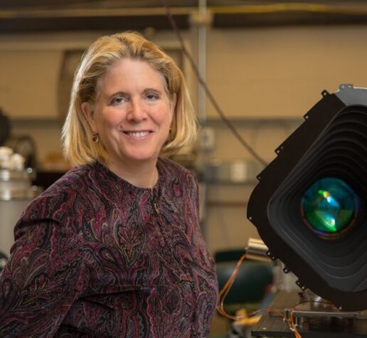 Jacqueline Hewitt stands with a prototype of one of the four cameras aboard the Transiting Exoplanet Satellite Survey (TESS) instrument.