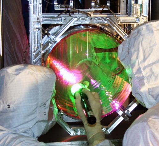 LIGO optics technicians examining one of LIGO's mirrors.