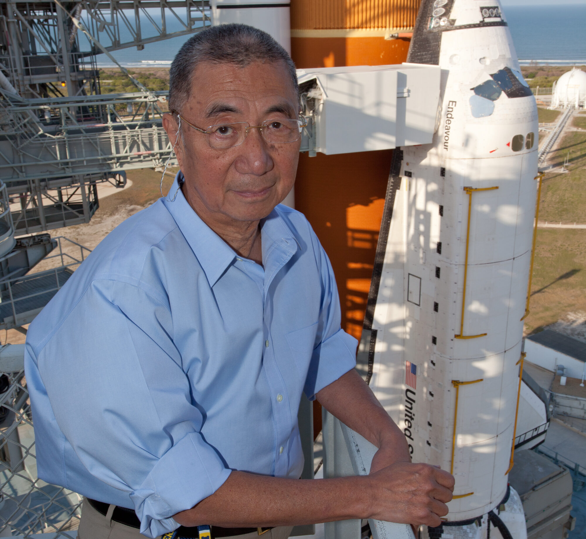 Professor Ting poses in front of the Space Shuttle Endeavor before it launches with AMS-02