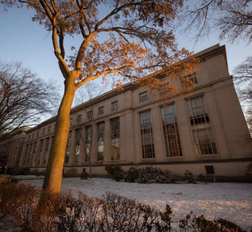 Photo of MIT building with a light cover of snow on the ground