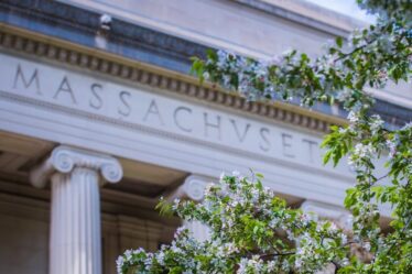 Photo of a flowering tree on the MIT campus, with the Great Dome in the background