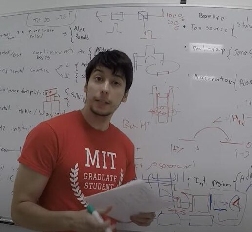 Alex Brinson raps in front of white board full of calculations