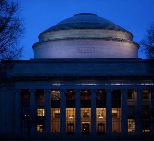 An image at night of the Great Dome on the MIT campus