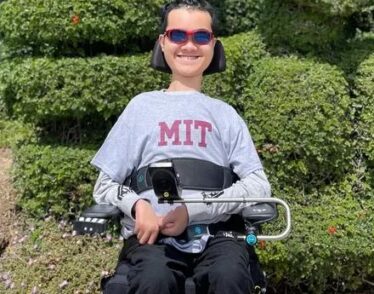 Undergraduate Ben Lou in motorized wheelchair wearing an MIT sweatshirt