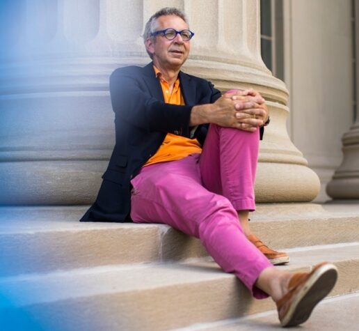 Peter Fisher sits on steps of Building 10