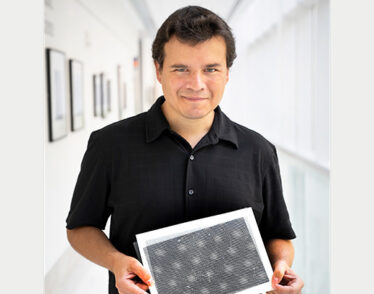 Man stands holding example of what moiré quantum matter looks like