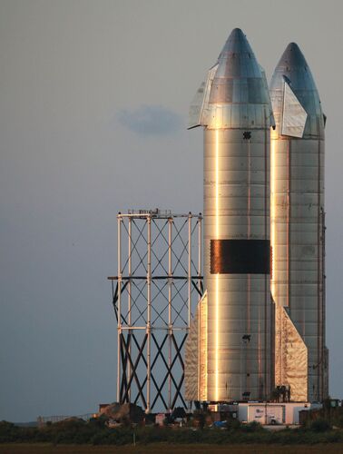 Starship rockets stand on the launchpad in Texas.