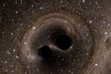 The collision of two black holes holes is seen in this still from a computer simulation.