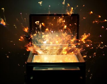 Conceptual image of an open box that has sparks flying out on a black background. The lid of the box resembles that of a laptop computer screen.