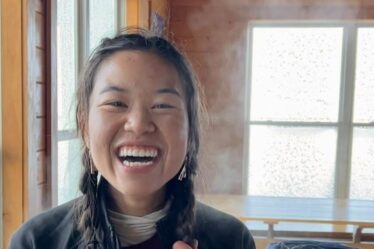 Minh-Thi Nguyen smiles holding her pigtails