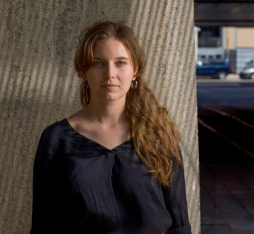 Dominika Ďurovčíková stands outside with MIT buildings in background.