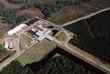 An aerial view of the Virgo site shows the Mode-Cleaner building, the Central building, the 3km-long west arm and the beginning of the north arm.