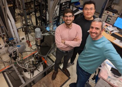 three physicists in their lab