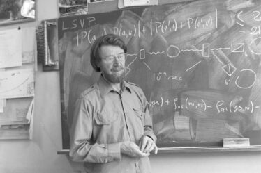 man stands in front of blackboard