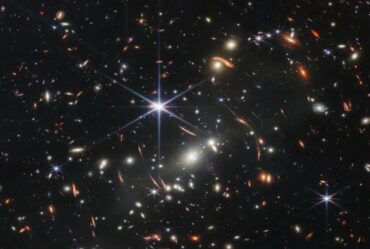 image of many galaxies with one bright starbust in middle