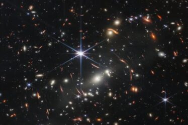 image of many galaxies with one bright starbust in middle