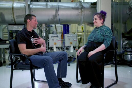 An image of two people sitting on chairs inside MIT LIGO Lab.