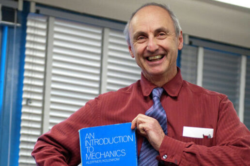 man poses with book titled 