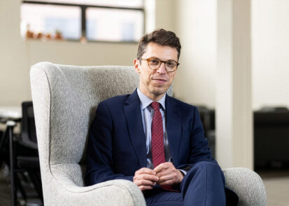 Nuno Loureiro sits in a white chair