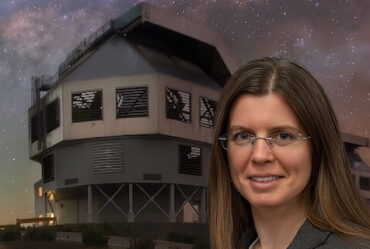 woman poses in front of Magellan telescope