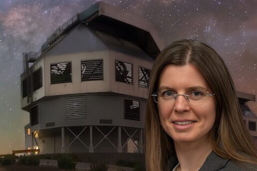 woman poses in front of Magellan telescope