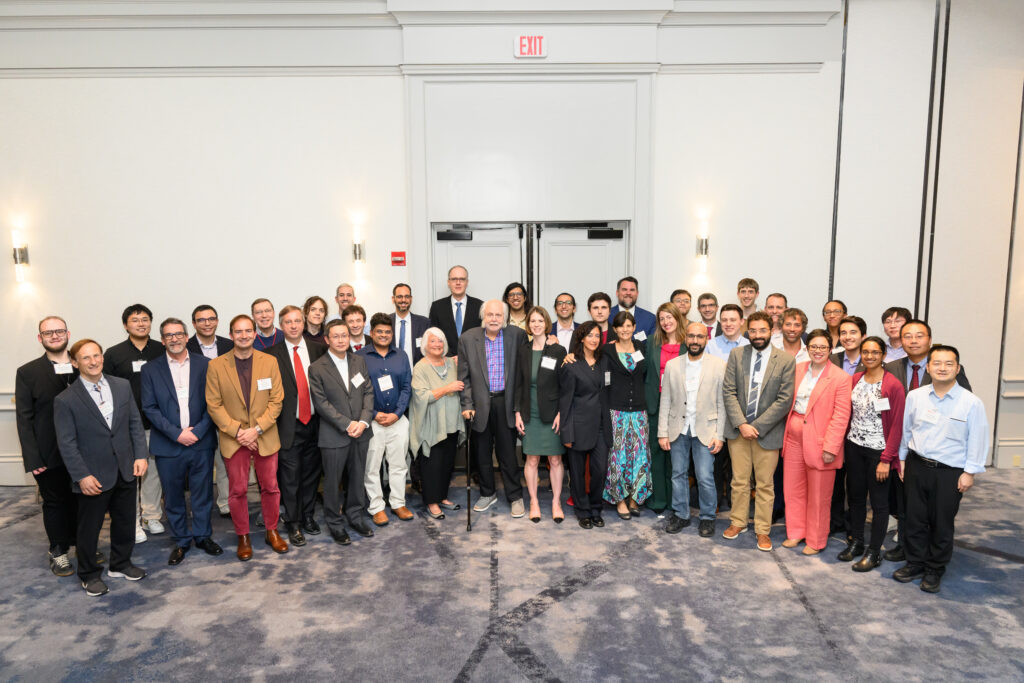 crowd of people pose for photo