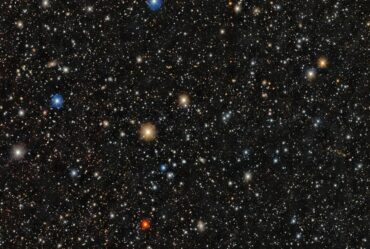 A dense star field shows thousands of stars of varying colors and brightness scattered across a dark background.