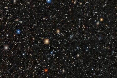 A dense star field shows thousands of stars of varying colors and brightness scattered across a dark background.