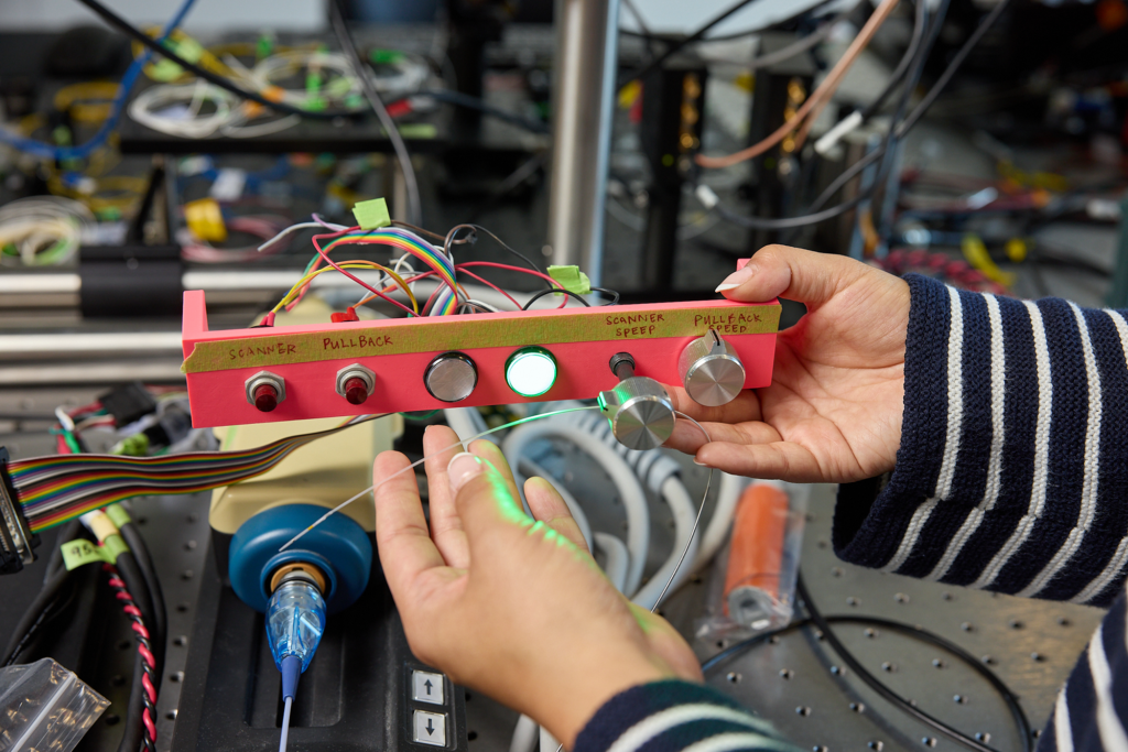 person holds prototype device with dials and buttons