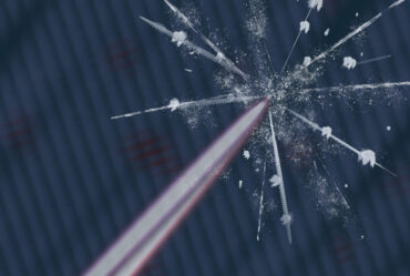 A laser beam hits a surface, causing a glass-like crack with white particles ejected.